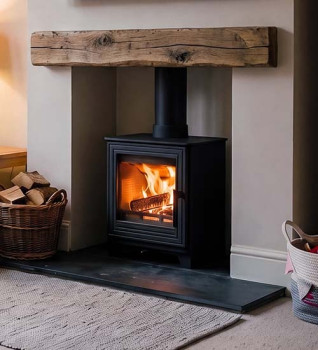 Woodford Pankhurst S Wood Burning Stove - Shown in a chimney breast with smooth finished chamber